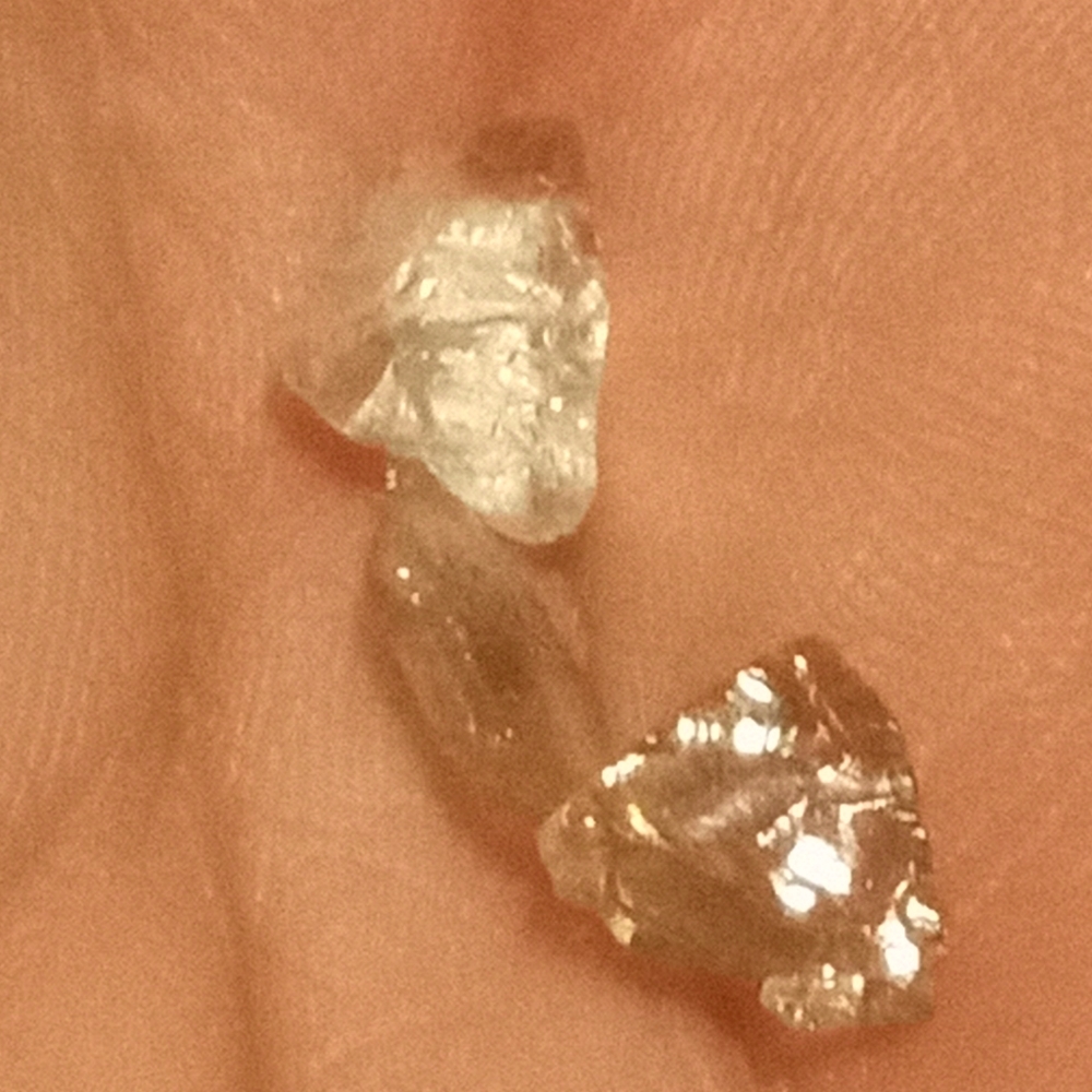 3 single diamonds.  jewelry store said they were real but I didn't get a weight.